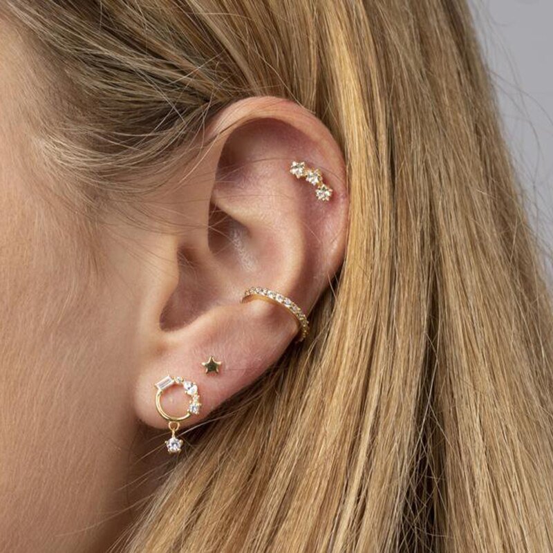 A model wearing the CZ Stars Curved Studs in her cartilage piercing.