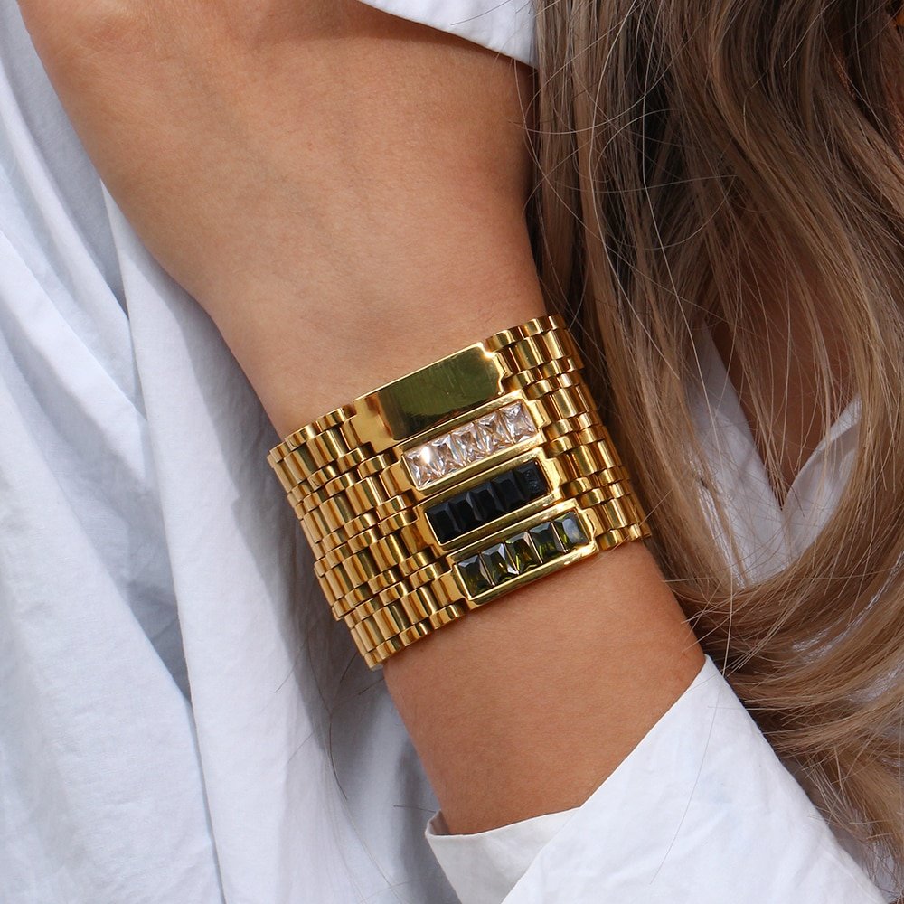 A woman wearing  four CZ Watchband Gold Bracelets.