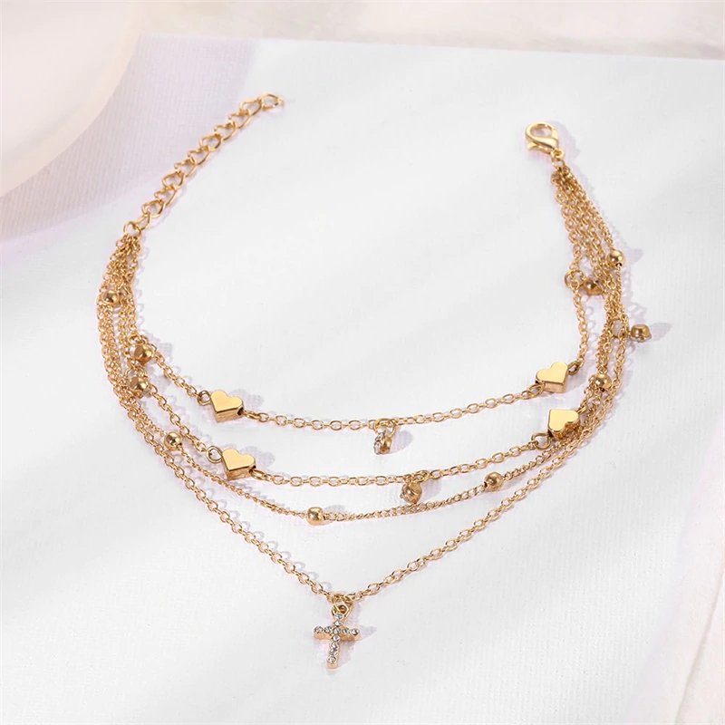 Closeup of the Dainty Cross Gold Anklet Set.