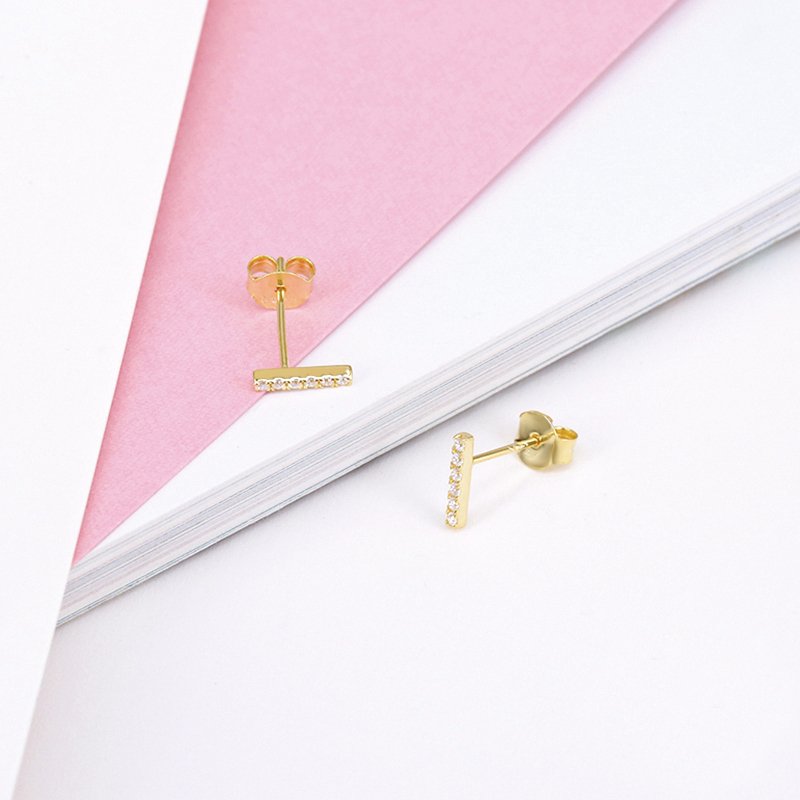 Minimalist CZ bar stud earrings in gold.