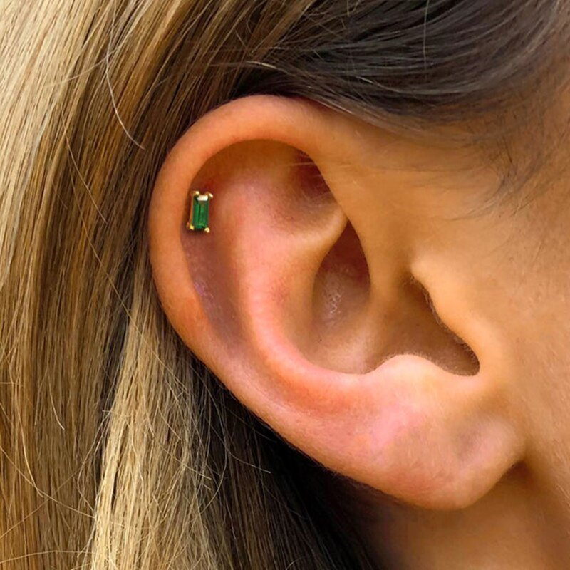 A model wearing the Emerald Cut CZ Studs in her cartilage.