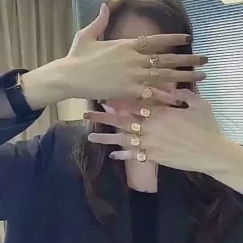 A video of a woman wearing a bunch of Chunky Gold Initial Rings.