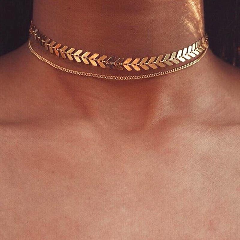 A model wearing the Fishbone Choker Layering Necklace Set.