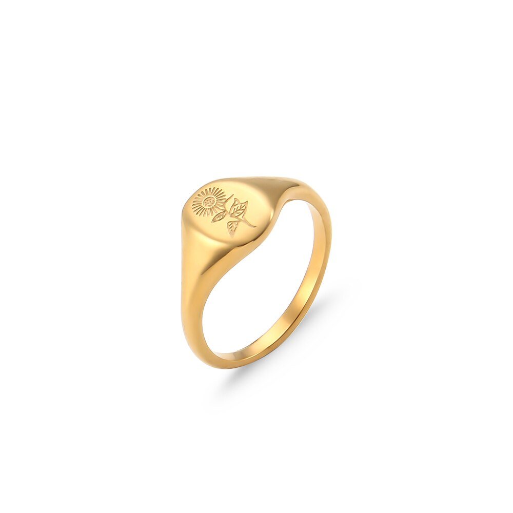 A sunflower engraved on a gold oval signet ring.