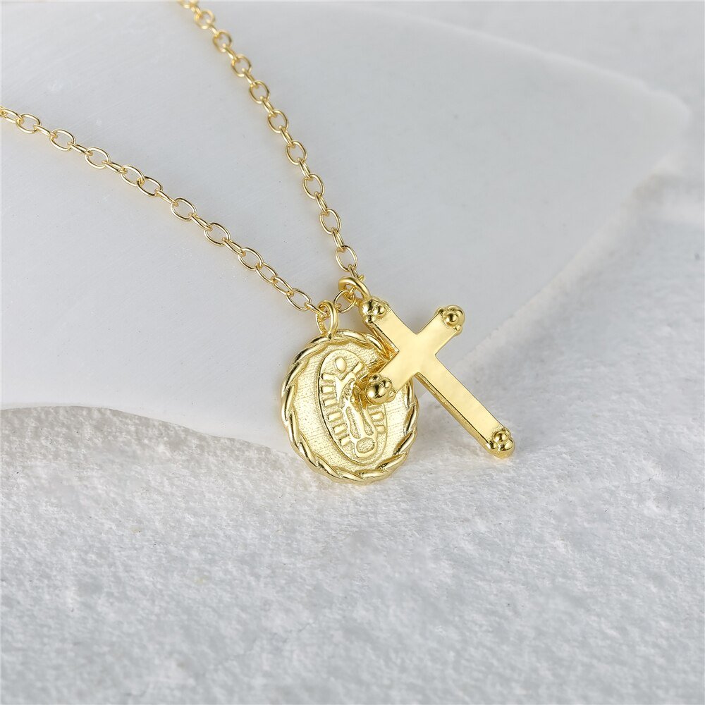 Closeup of the Gold Cross Charm Necklace.