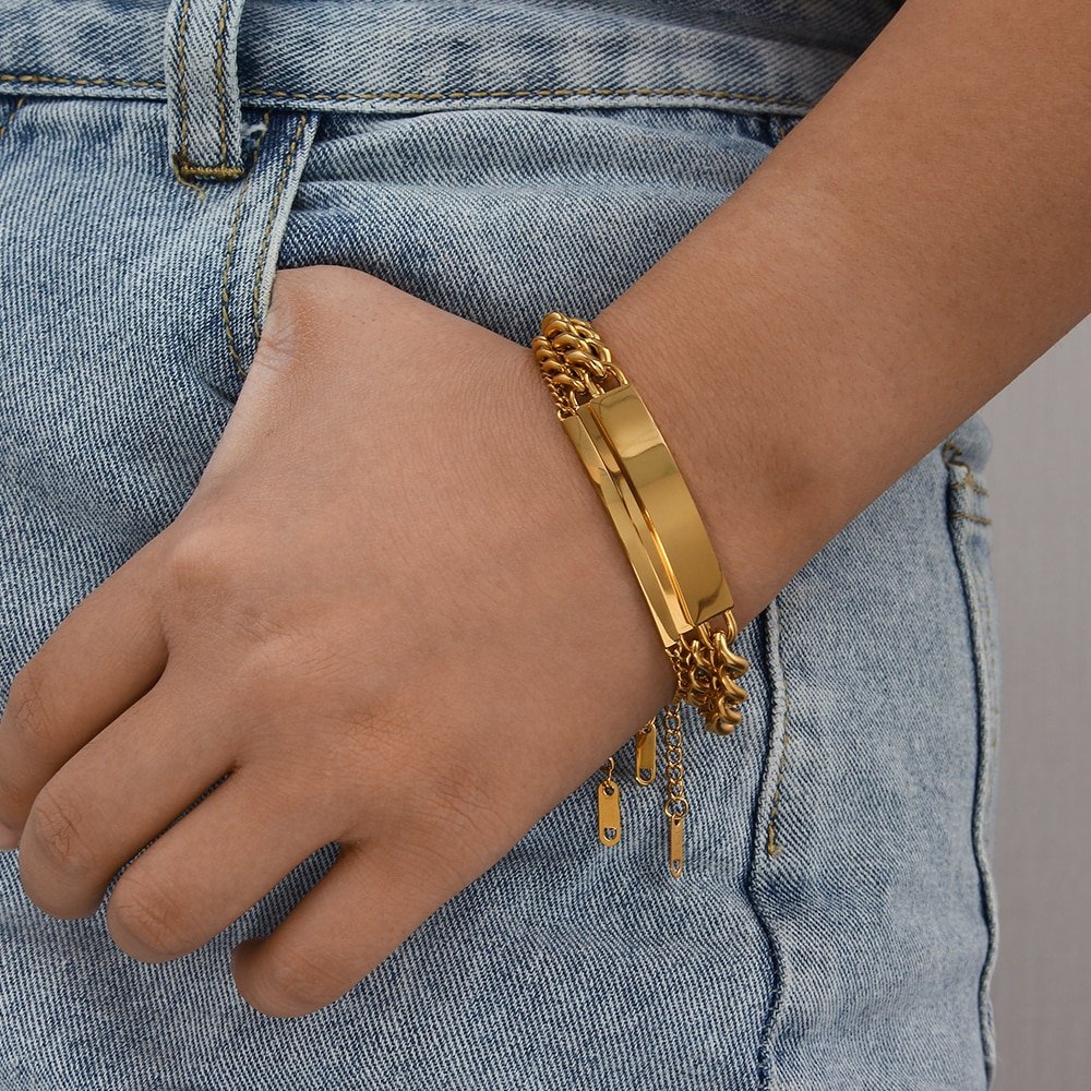 A woman wearing the Gold Cuban Link Plate Bracelet.