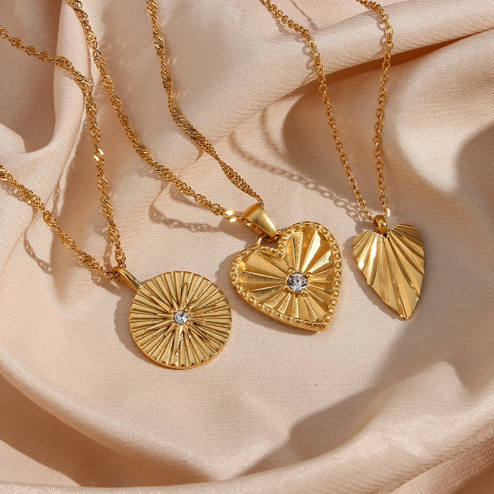 Three gold heart necklaces.