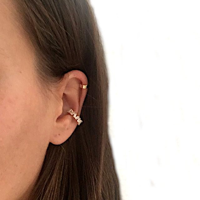 A woman wearing the gold Icy Ear Cuff.