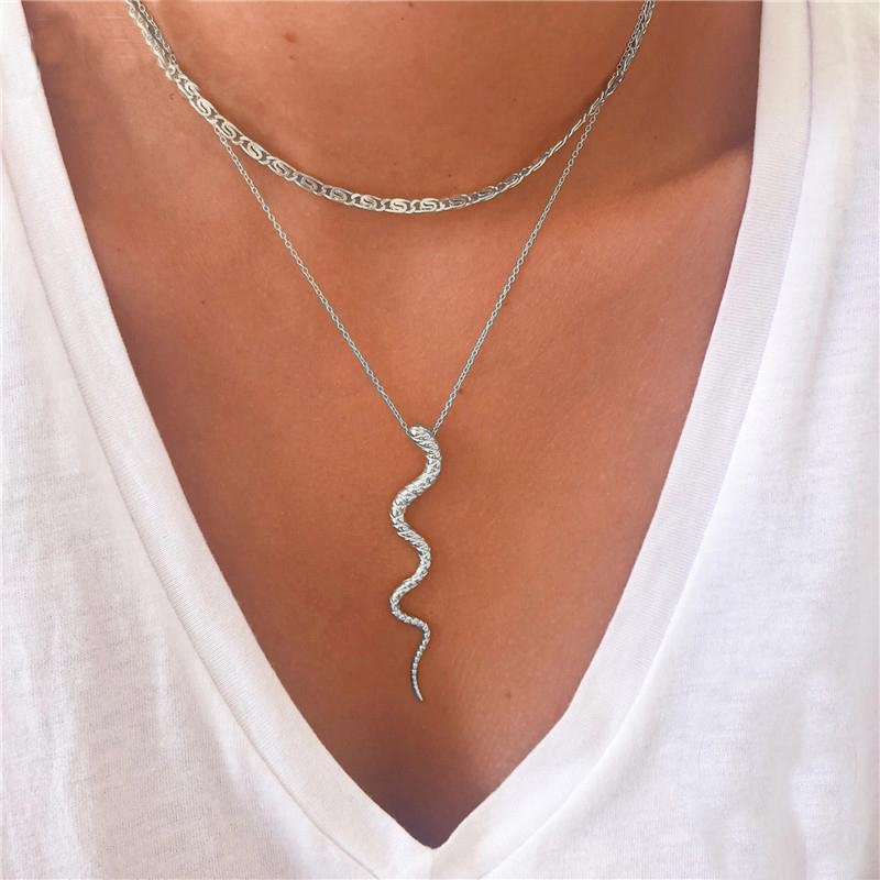 A model wearing a silver snake necklace.