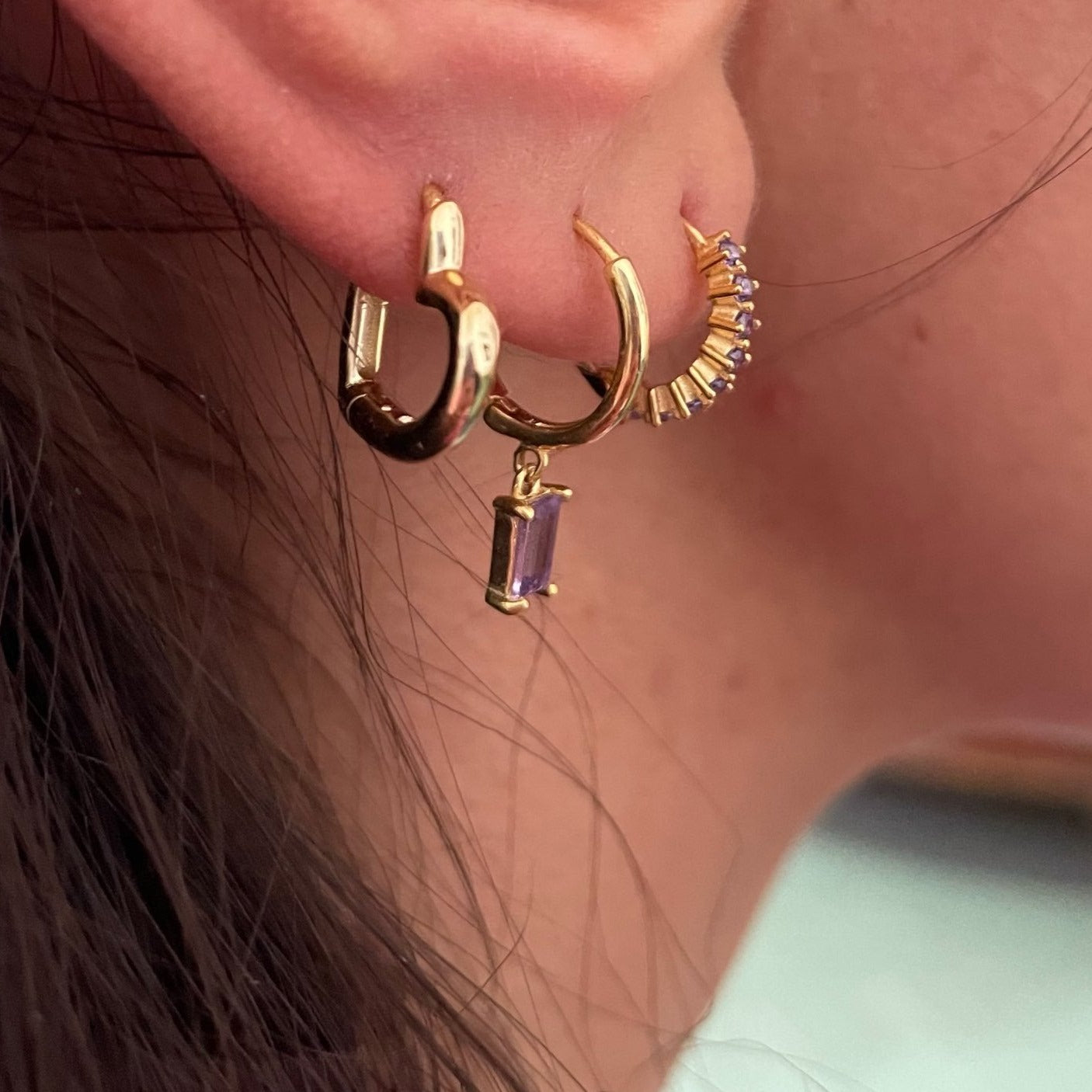 Closeup of gold hoop earrings.