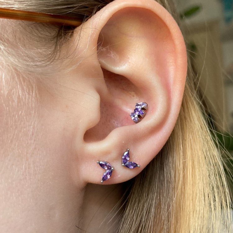 A woman wearing two Lilac Marquise Studs.
