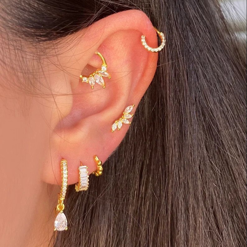 A model wearing the gold marquise crown cartilage stud earring.
