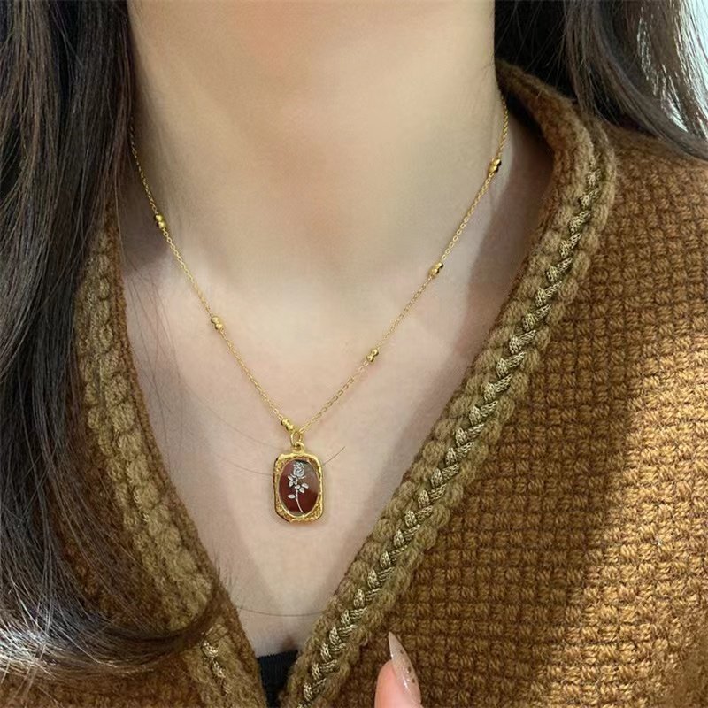 A model wearing the Mirrored Birth Flower Gold Necklace.