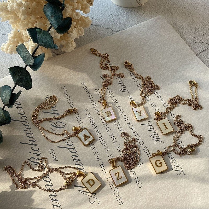 Multiple gold mother of pearl shell monogram necklaces bridemaids gifts.