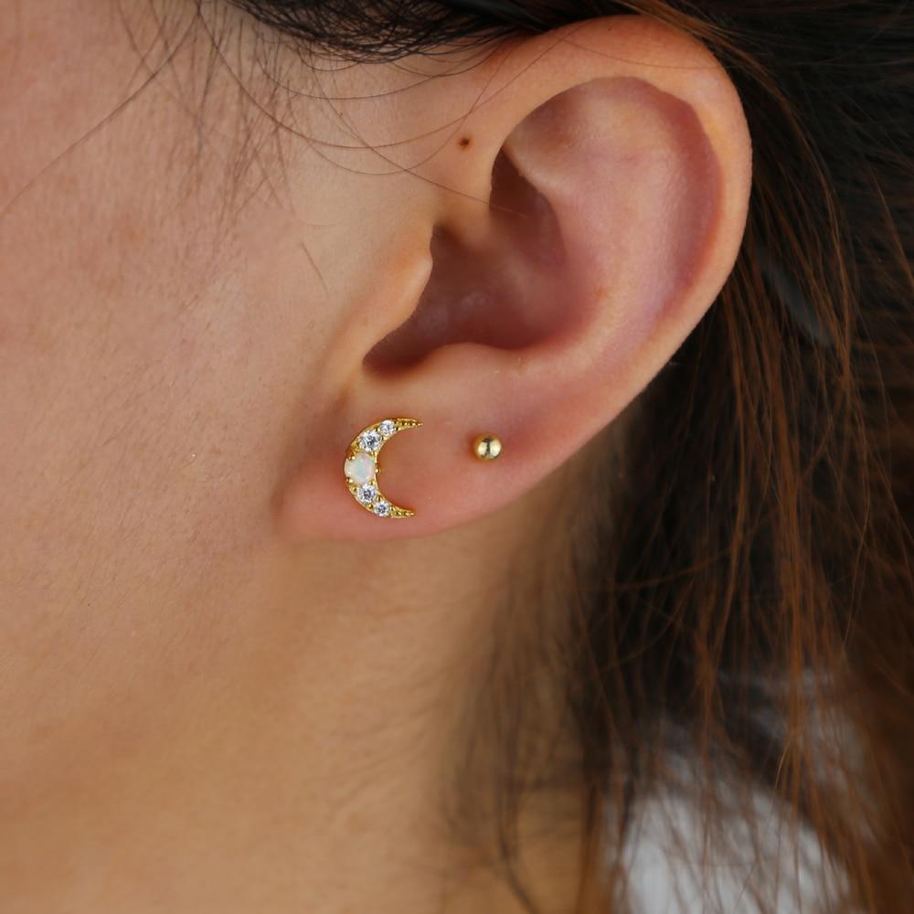 A model wearing the Opal Crescent Moon Gold Earrings.