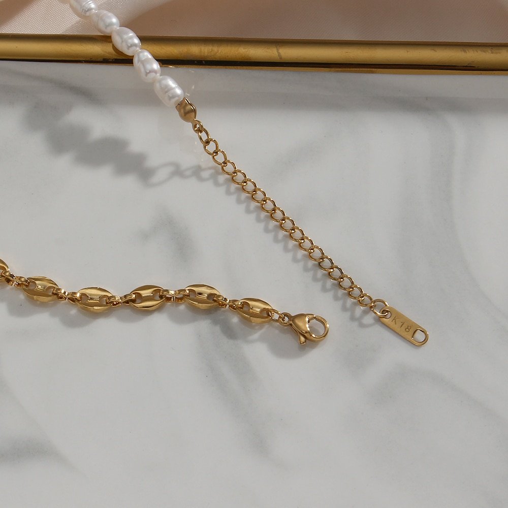 Closeup of the clasp of the Pearl Anchor Chain Gold necklace.