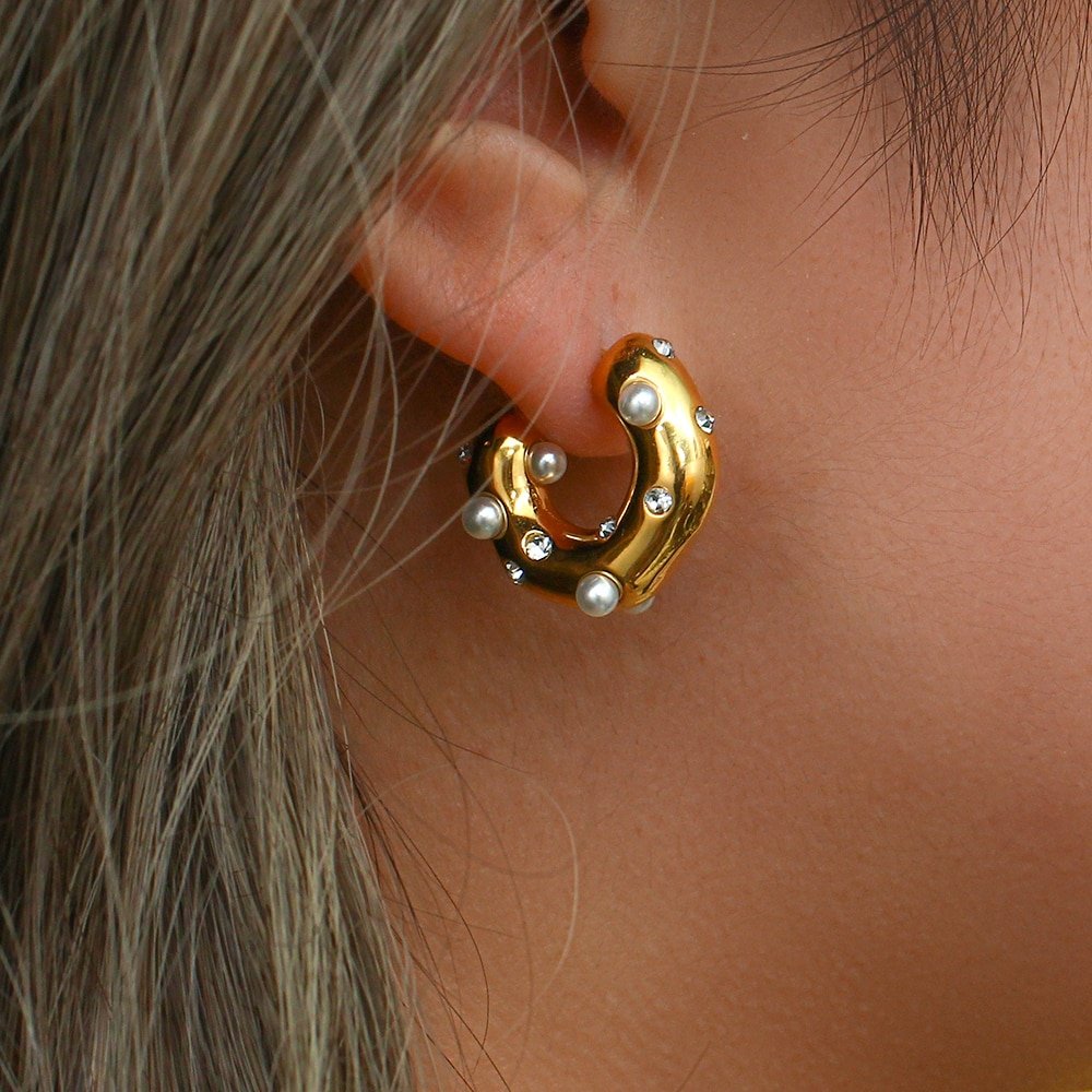 A model wearing the Pearl Barnacle Gold Hoops.