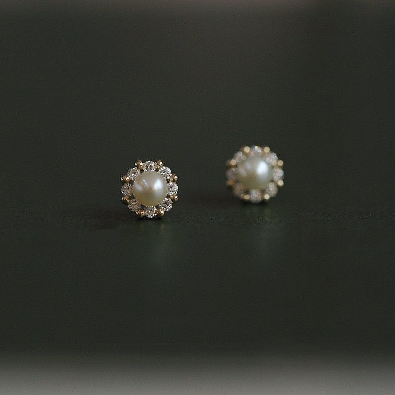 Tiny pearl studs with a halo of CZ stones.