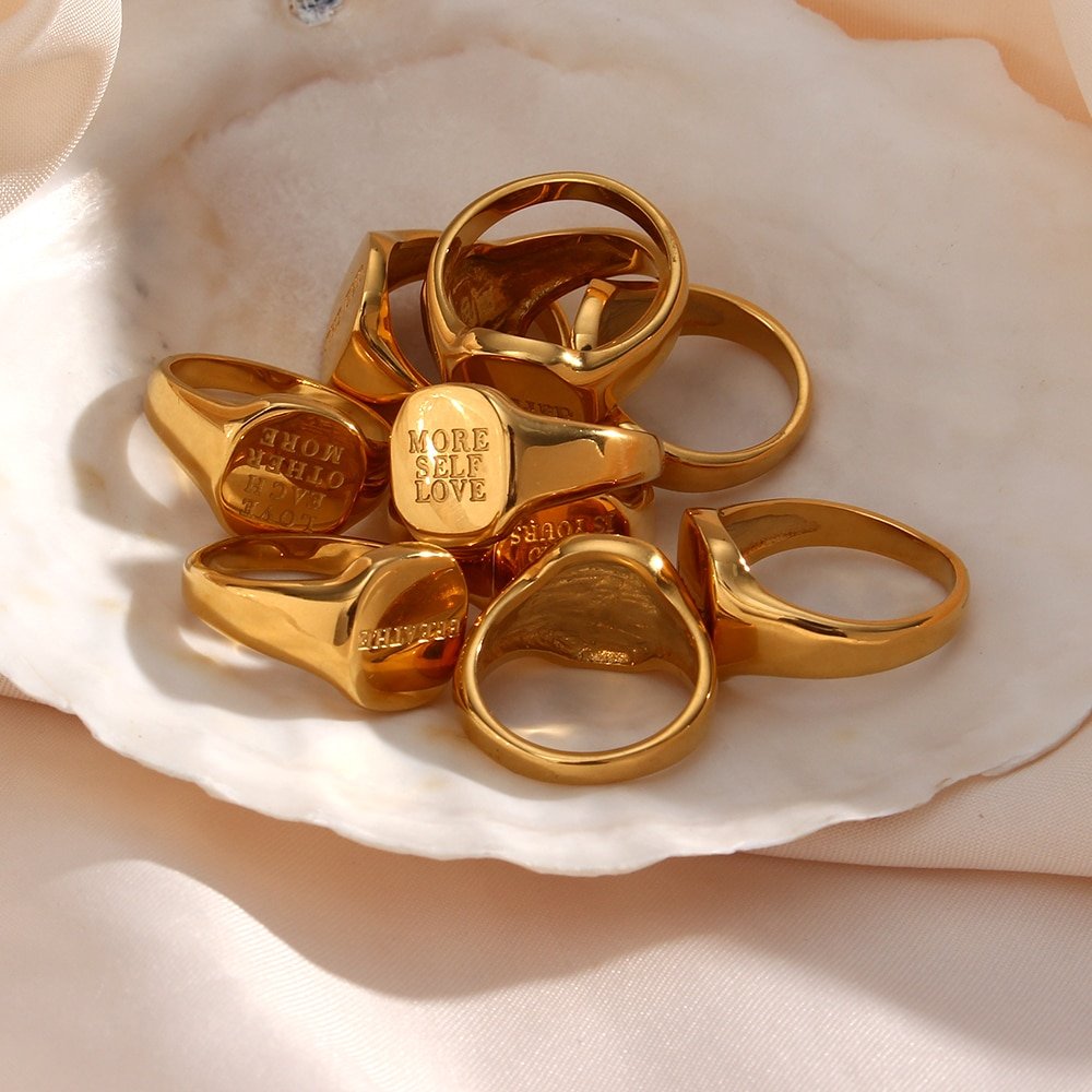 A bunch of gold rings in a bowl.