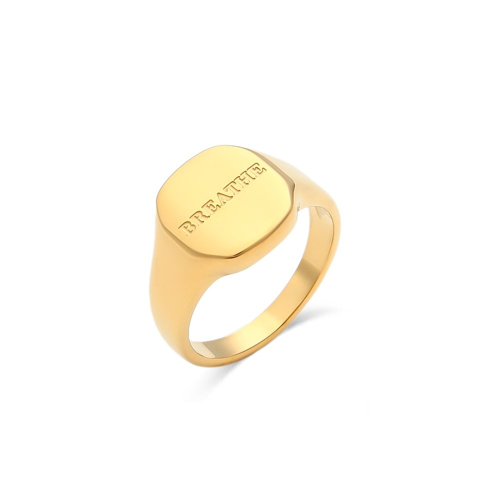 Gold signet ring engraved with "Breathe".