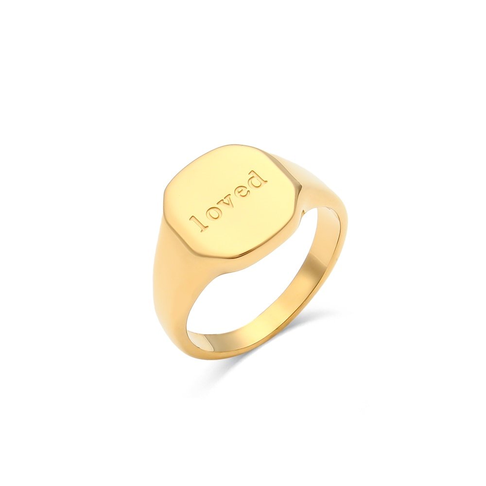 The word "Loved" engraved on a gold signet ring.