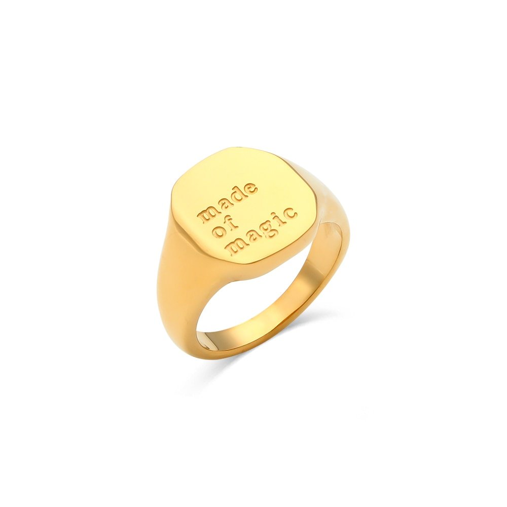 "Made of Magic" engraved gold signet ring.
