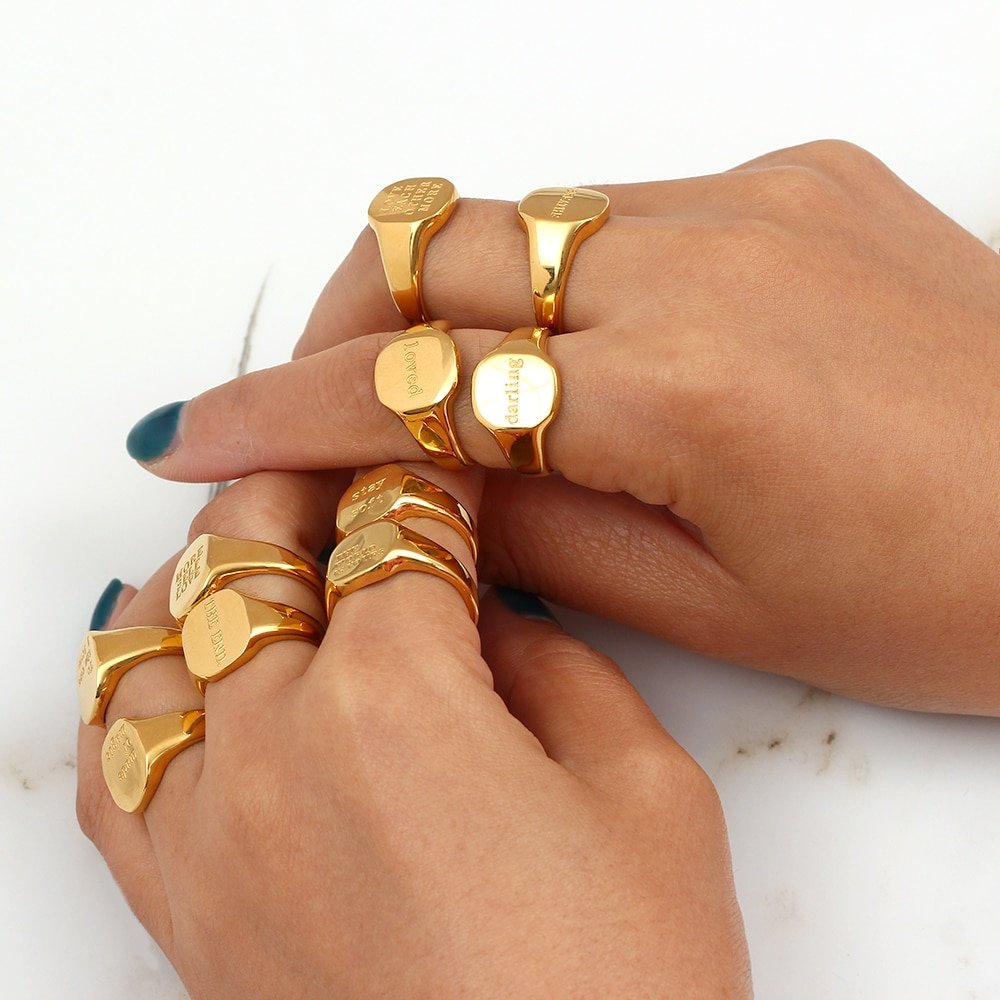 A model wearing a bunch of chunky gold rings.