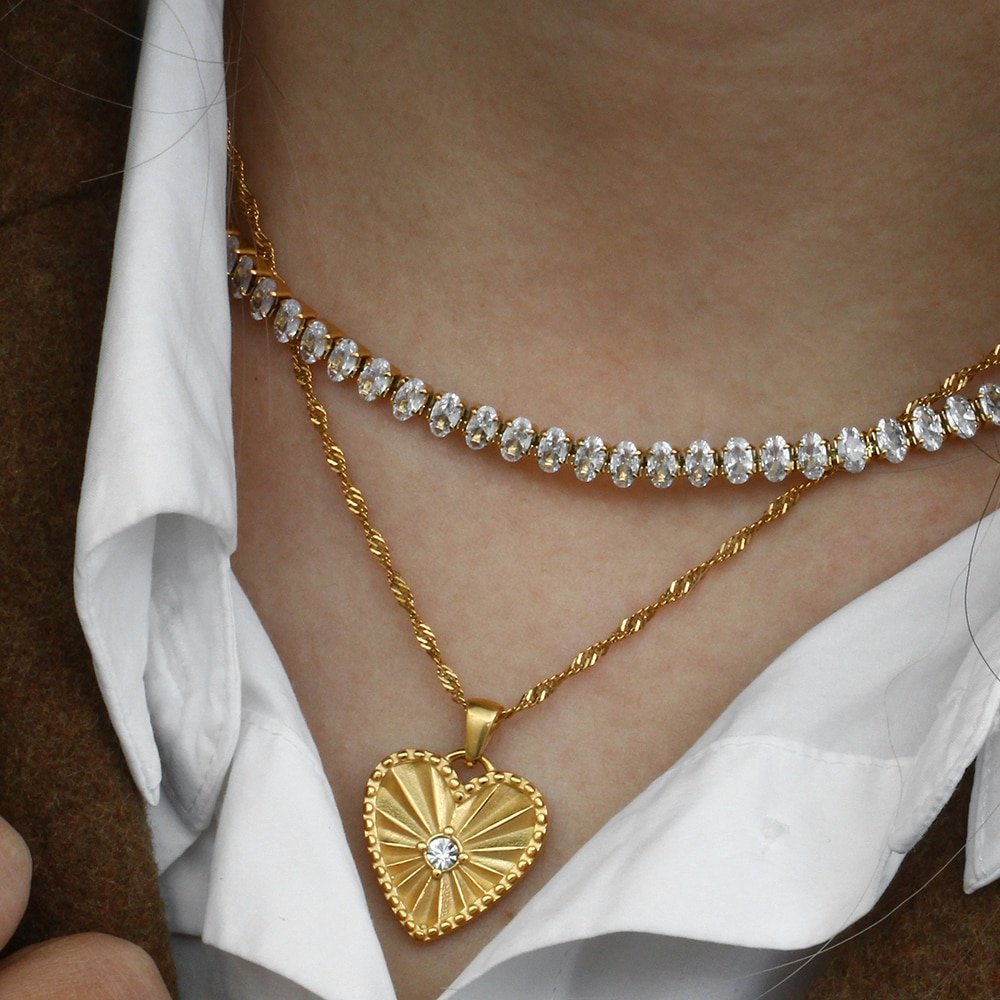 A model wearing the Gold Radiating Heart Necklace.