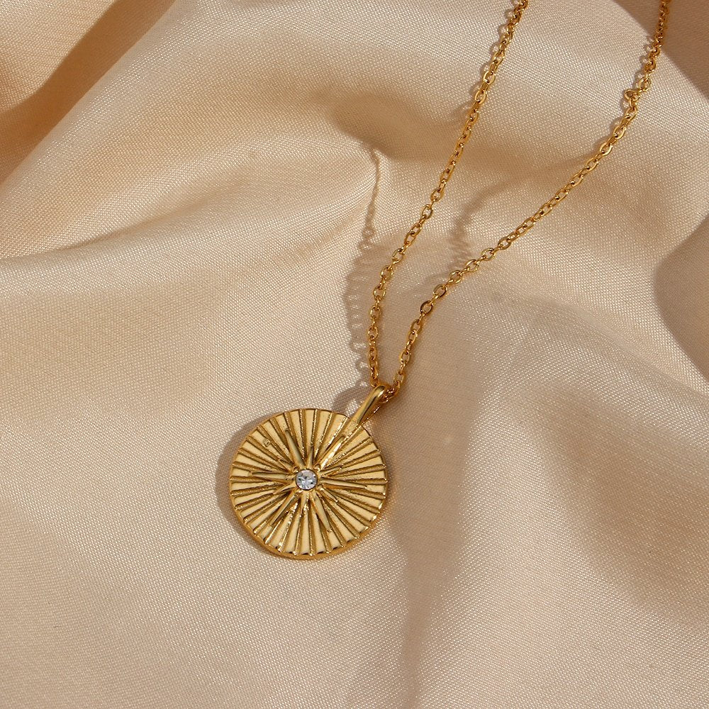Gold coin pendant with a CZ star.
