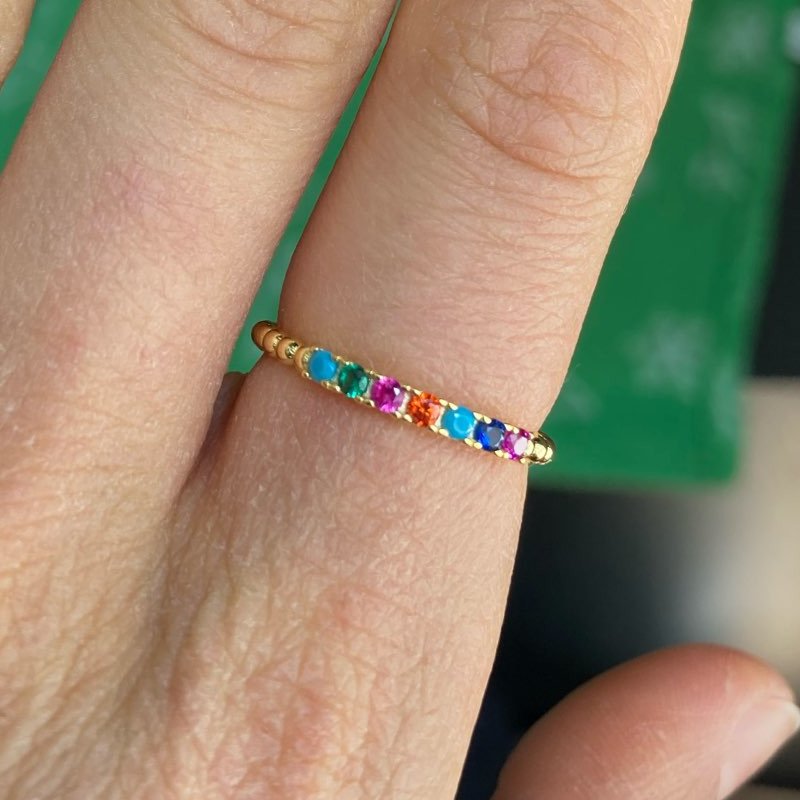 A woman wearing the gold Rainbow CZ Beaded Ring.