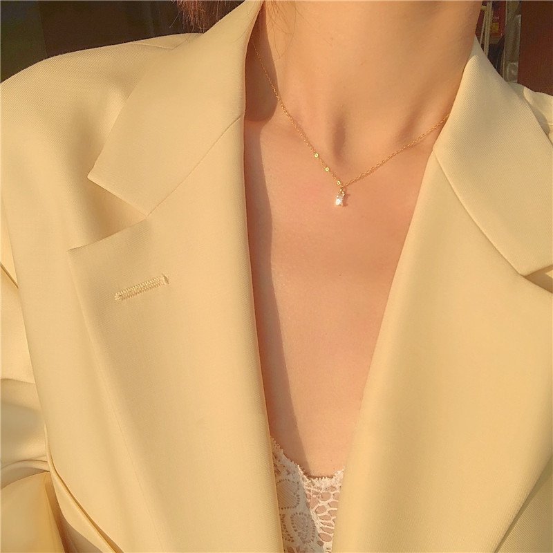 A woman wearing the Rectangle CZ Dainty Necklace.