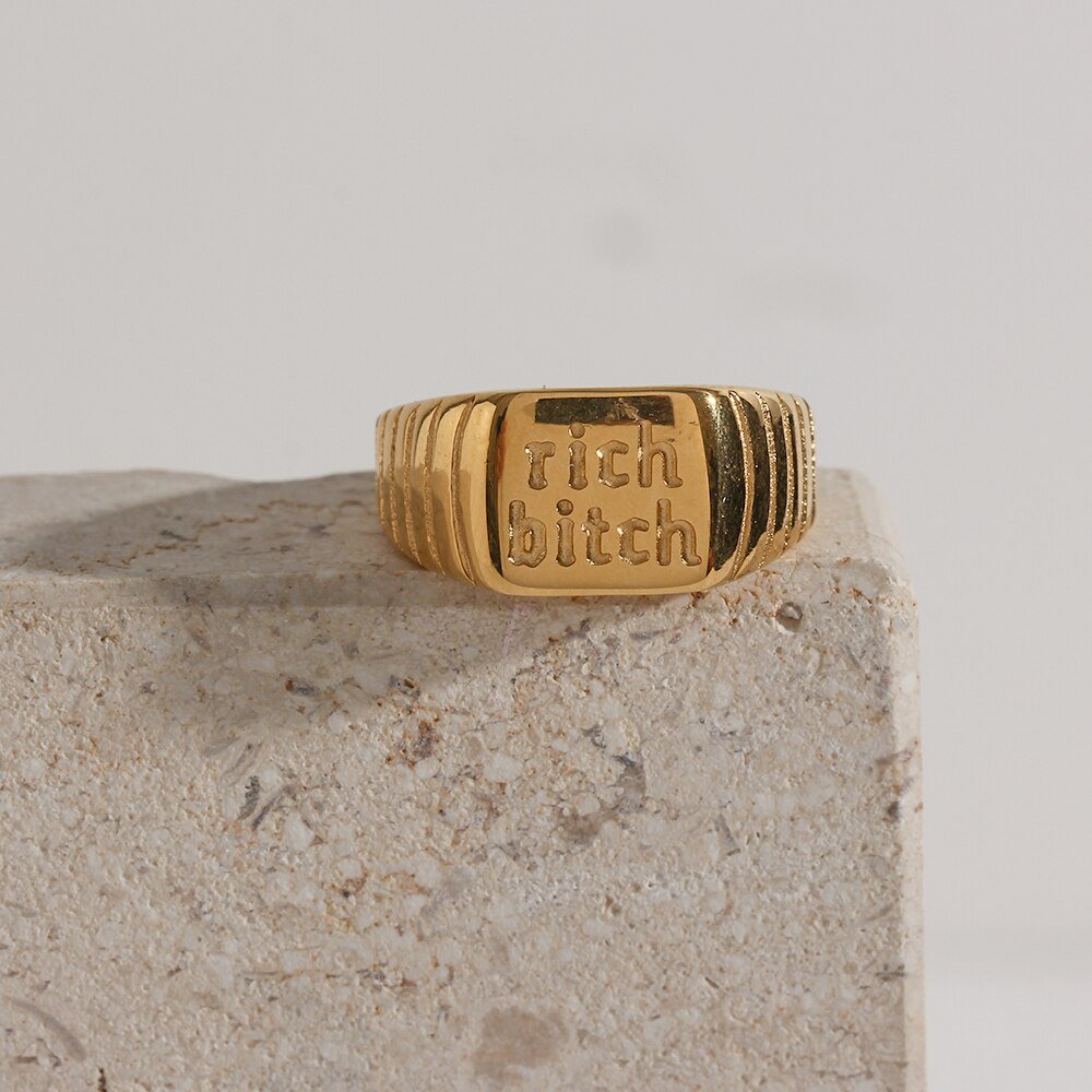 Closeup of the Rich Bitch Gold Signet Ring.