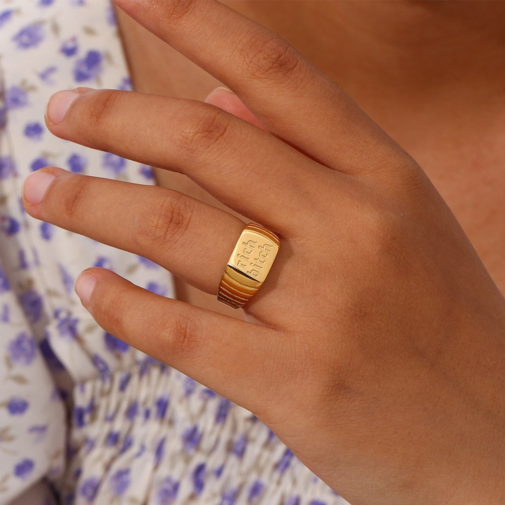 A model wearing the Rich Bitch Gold Signet Ring.