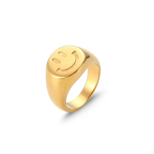 Gold smiley face signet ring.