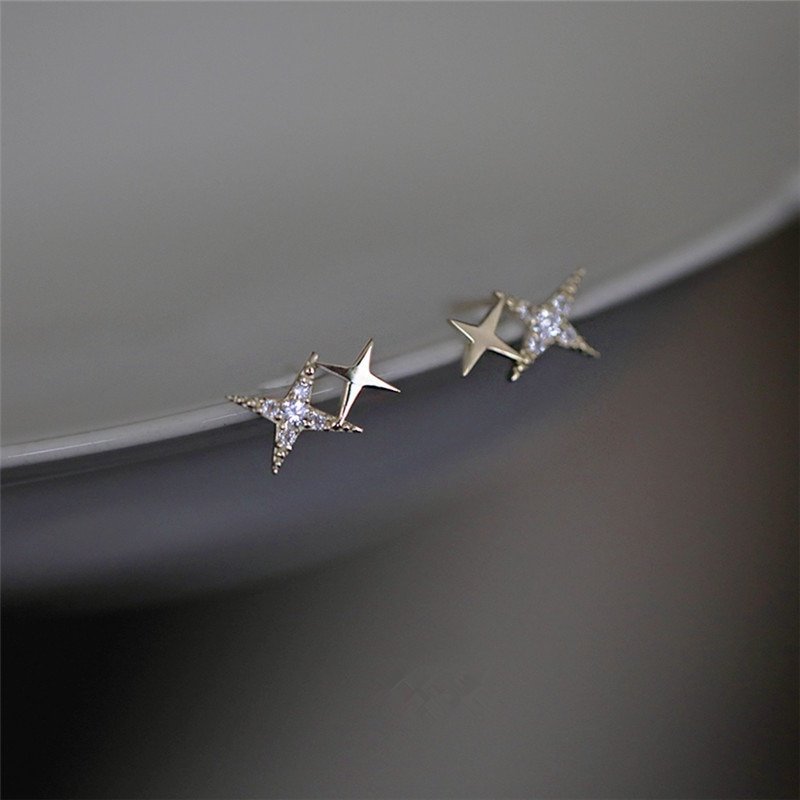 Tiny star stud earrings with sparkling CZ stones.