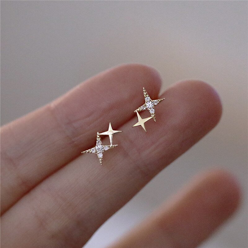 A woman holding the Sparkle Star Stud Earrings.