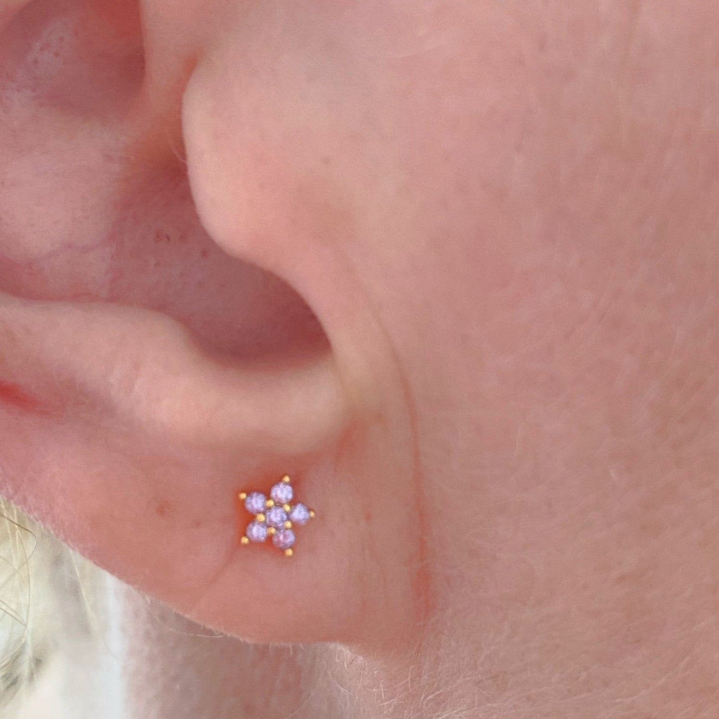 A model wearing the lilac Spring Flower CZ Studs.