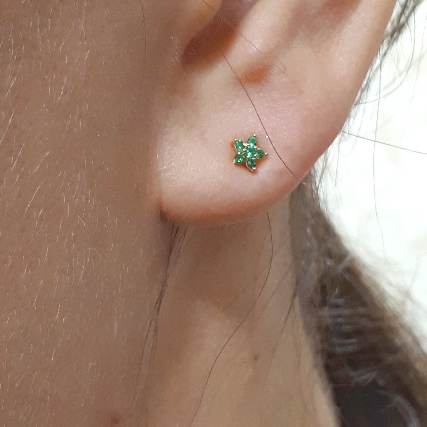 A model wearing the green Spring Flower CZ Studs.