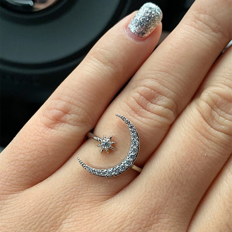 Star Crescent Moon Ring in silver being modeled on a woman's hand.