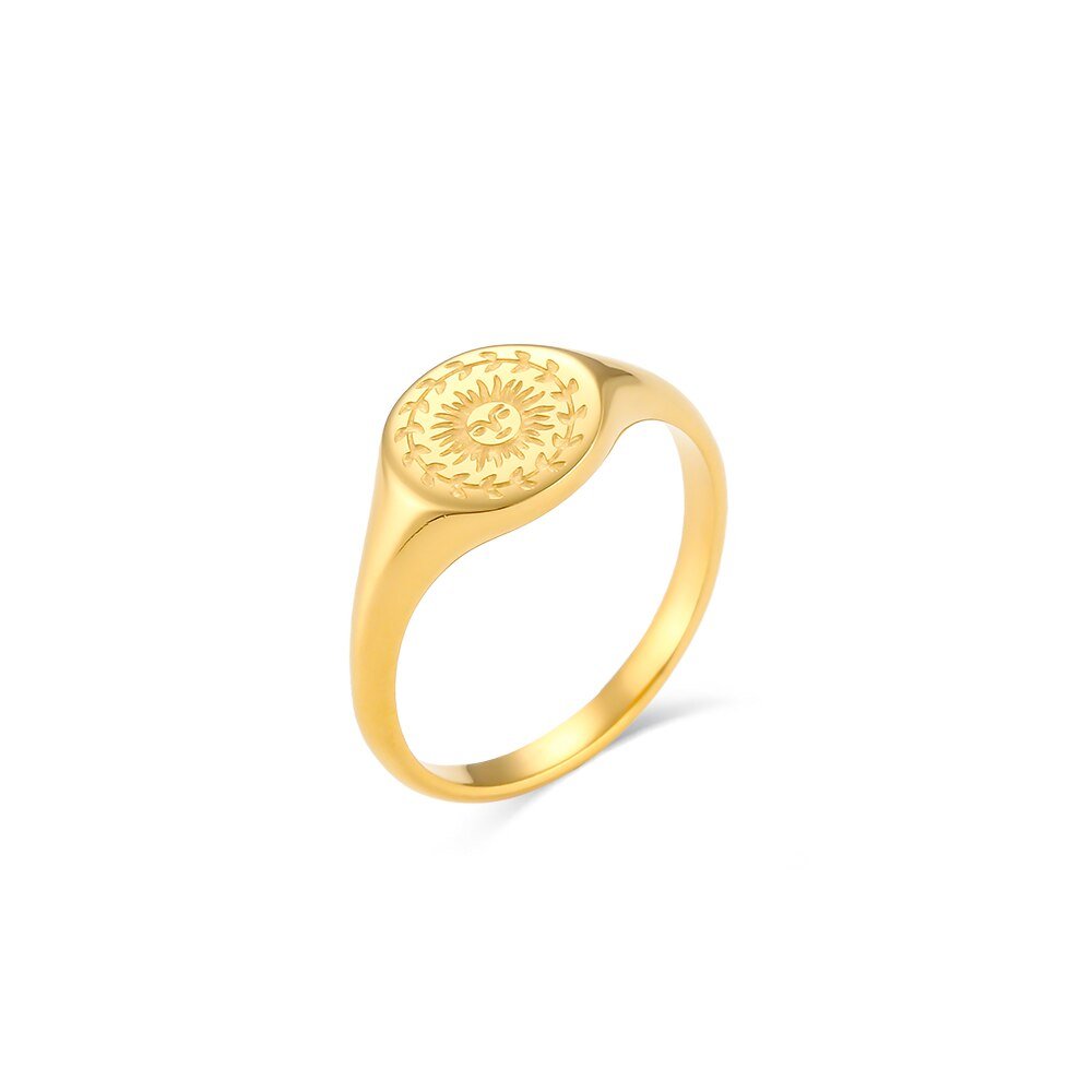 Gold signet ring with sun engraving.