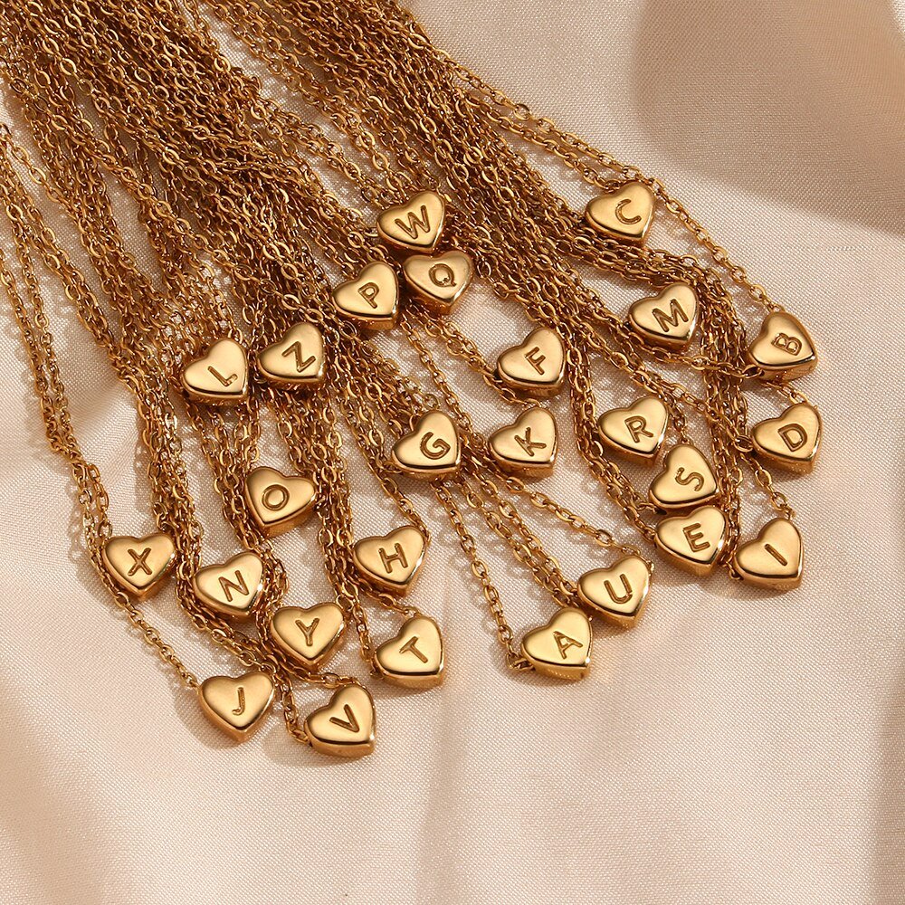 26 Gold heart initial necklaces.