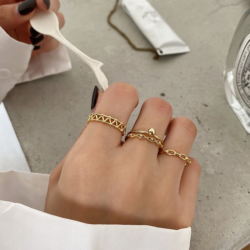 A model wearing multiple minimalist gold stacking rings.