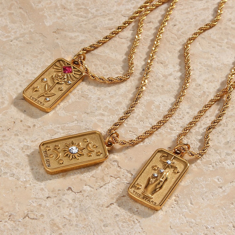 Gold tarot card necklaces on a rope chain.