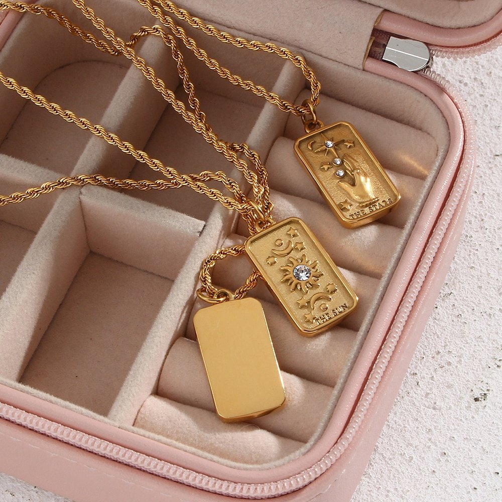 Gold tarot card necklace in a jewelry box.