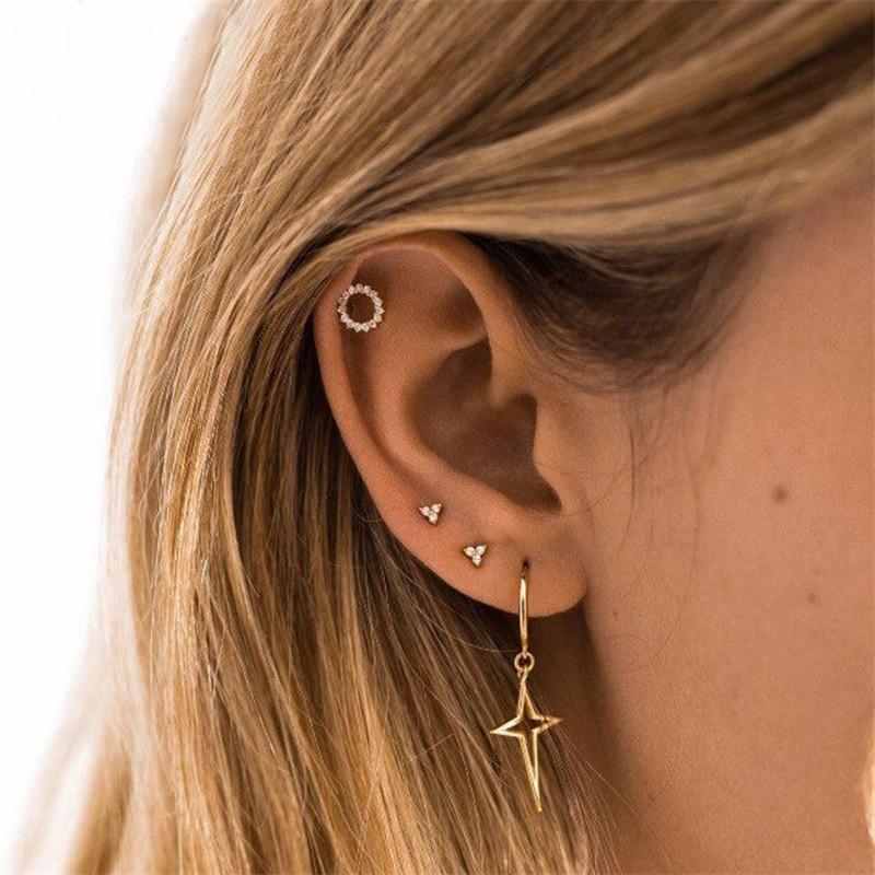 A model wearing multiple Trinity CZ Stud Earrings.