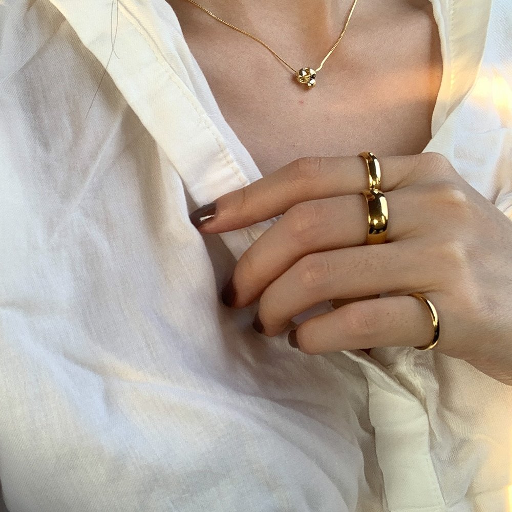 A model wearing chunky gold rings.