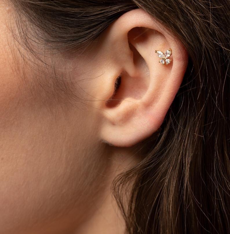 A model wearing the Tiny Crystal Butterfly Cartilage Stud.