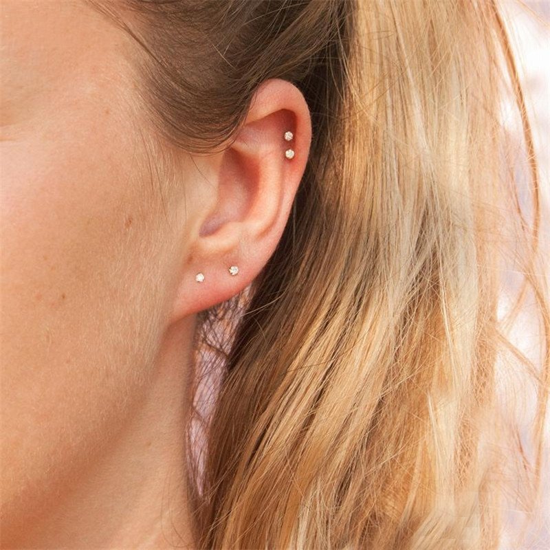 A model wearing multiple tiny CZ stud ear piercings.