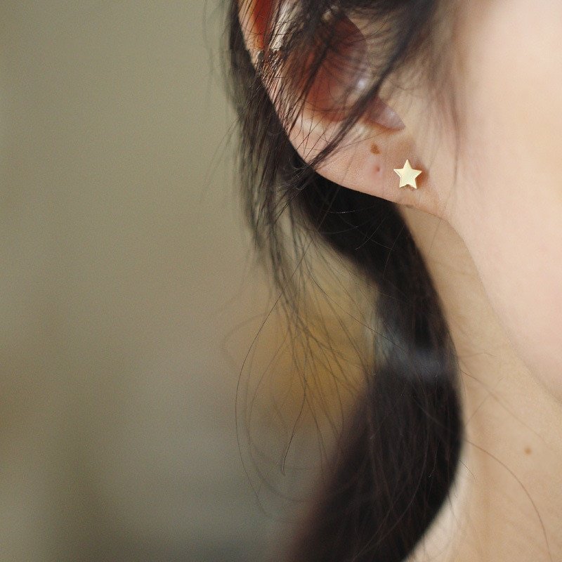 A model wearing the Tiny Star Studs.