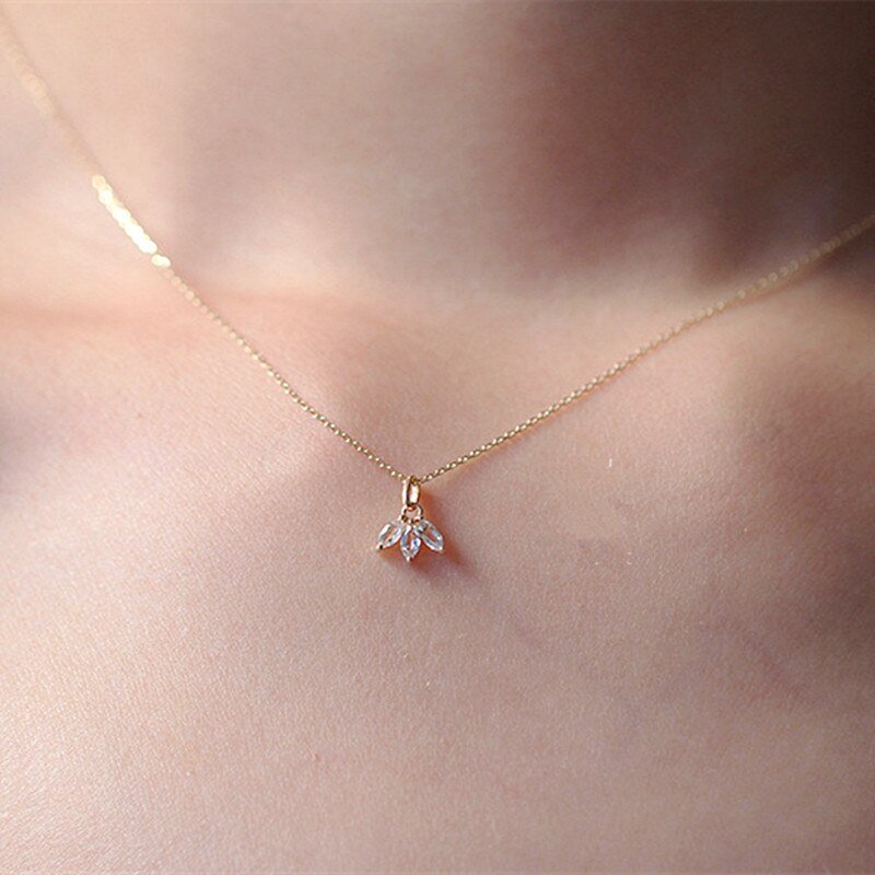 A woman wearing a delicate marquise CZ necklace.